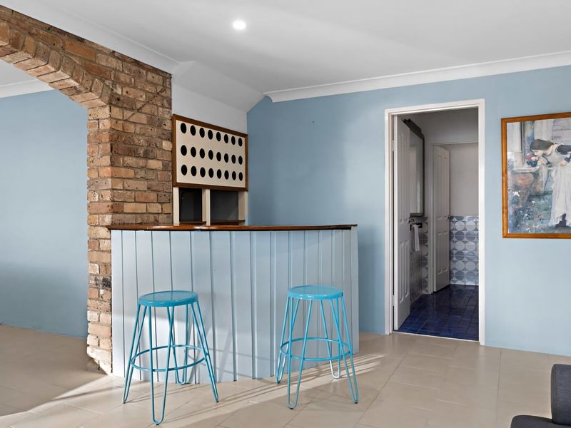 Bar area with brick feature wall and casual seating.
