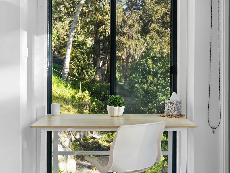 Quiet workspace nook overlooking lush greenery.