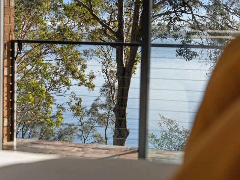Tranquil water views framed by large windows.