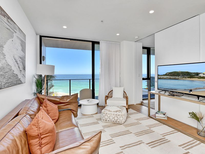 A sophisticated apartment in a new coastal tower, offering unrivaled ocean views, high-end finishes, and essential modern features including in-unit laundry.