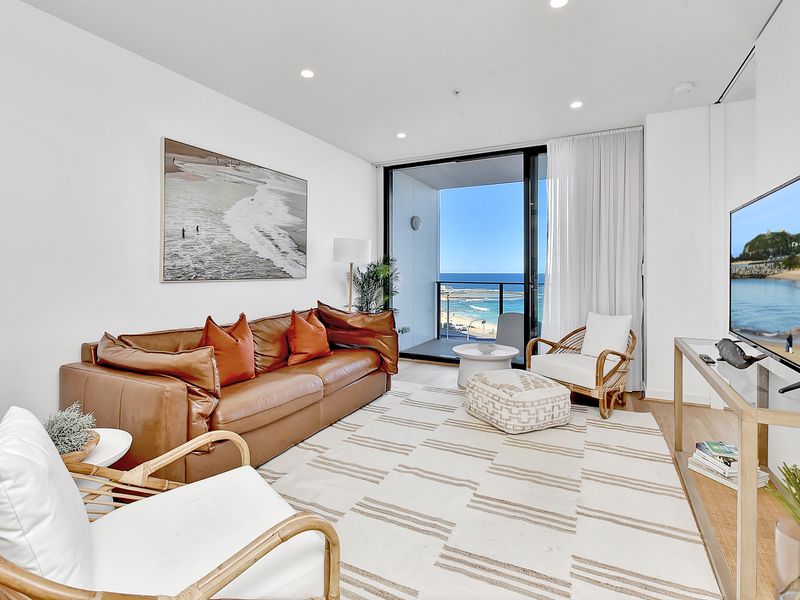 Bright coastal living room with ocean views, modern decor and a private balcony.