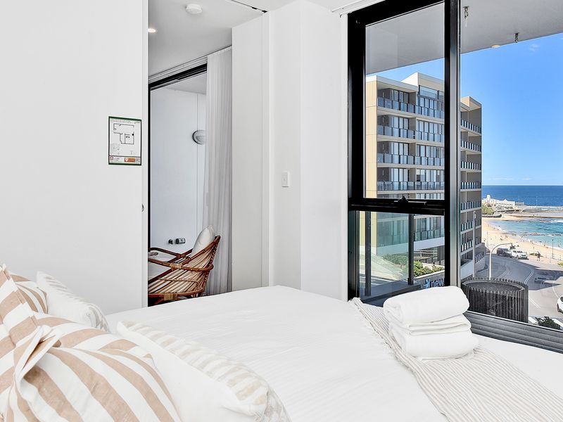 Bright bedroom with ocean views, modern furnishings and a relaxing coastal vibe.