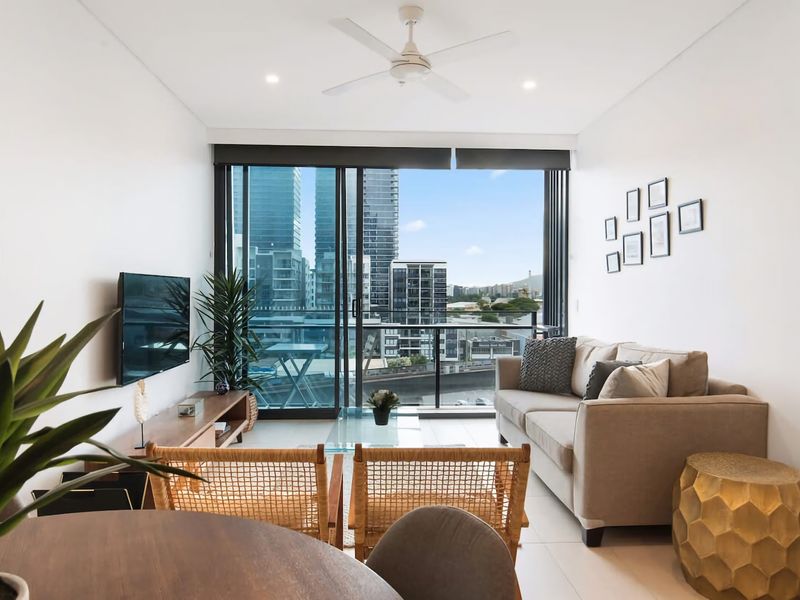 The modern aesthetic of this property stands out in its sleekly designed living area and open-plan kitchen, where clean, minimalist design successfully maximizes space without sacrificing on style.