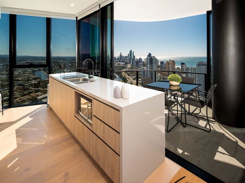 The kitchen exudes contemporary elegance with reconstituted stone benchtops and high-quality appliances.