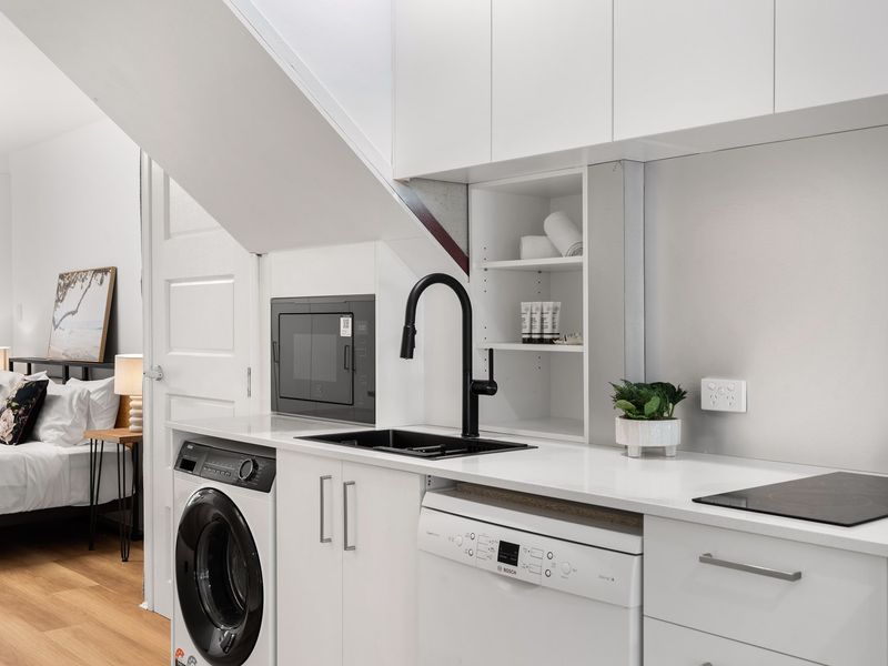 Cook and clean with ease in the private suite kitchen featuring modern amenities.