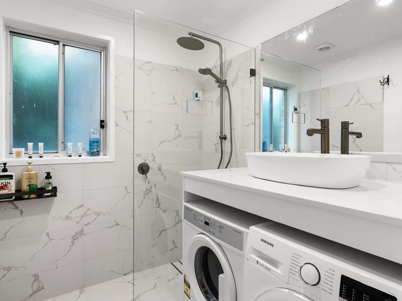 Convenient bathroom with an in-unit washer and dryer for your convenience.