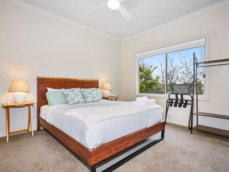 Bedroom 2: Elegant queen bed with soft linen
