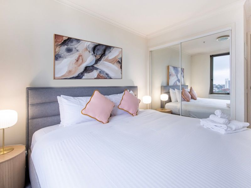 Comfortable bedroom with soft linens and natural light