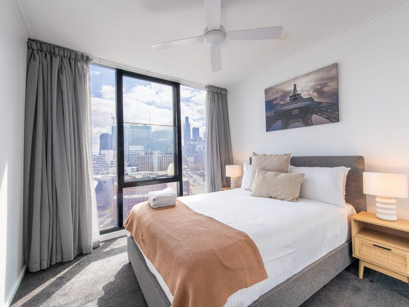 Cozy bedroom with outside view and stylish bedside lamps
