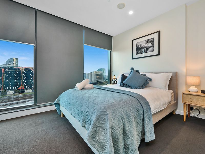 Master bedroom – queen bed, large windows and city views