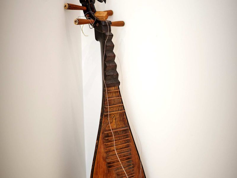 Antique stringed instrument displayed in the corner