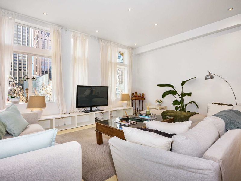 Bright and airy living room with large windows offering city views