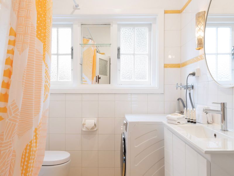 Bathroom with full size bath, natural light and classic tiled finishes