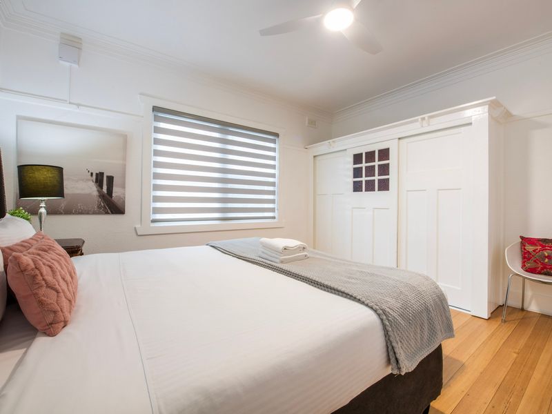 ight filled bedroom with neutral tones, built in storage and a peaceful atmosphere