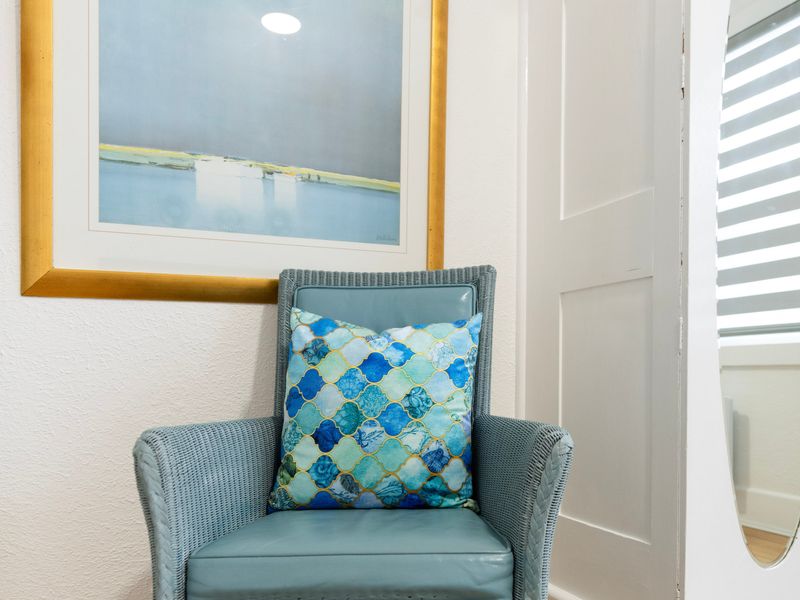 Styled corner with accent chair and artwork adding warmth and personality