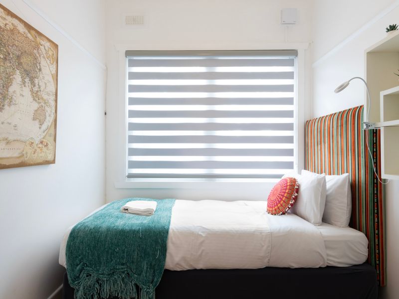 Compact single bedroom with colourful touches and a cosy, private feel