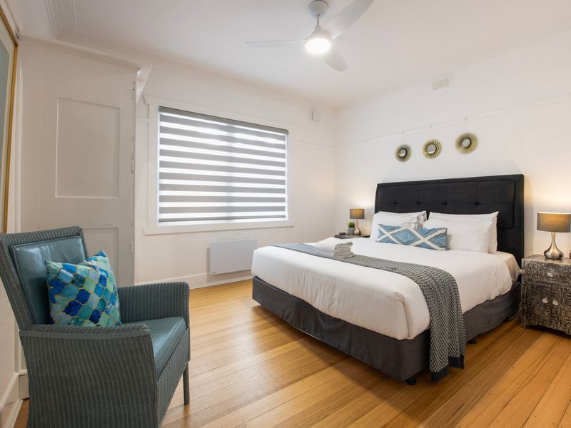 Well proportioned king bedroom with cosy bedding and a welcoming layout