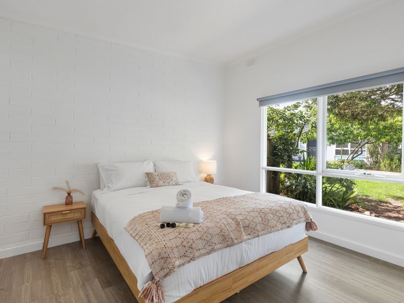 Master bedroom with queen bed and garden views