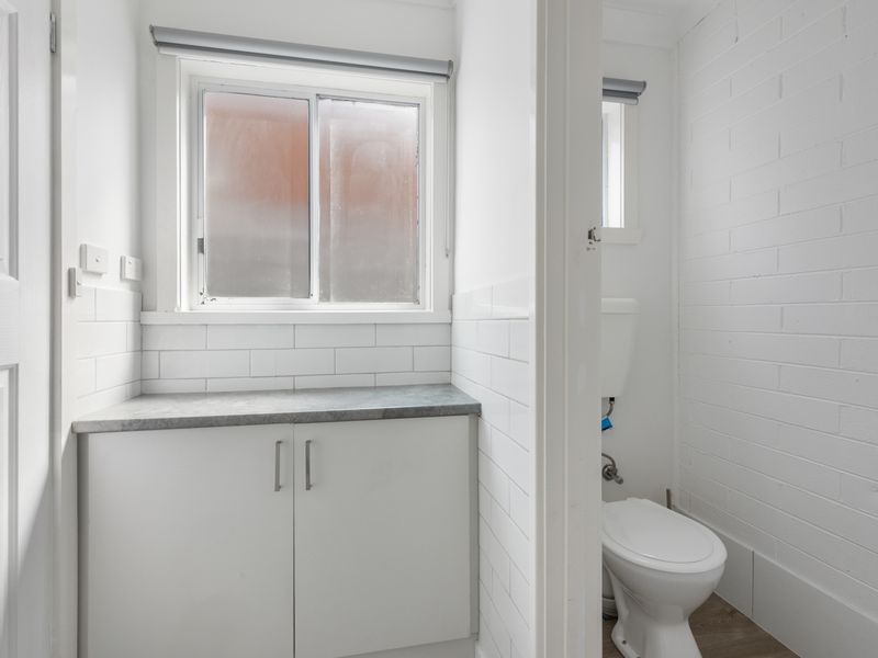 Main bathroom with storage and toilet