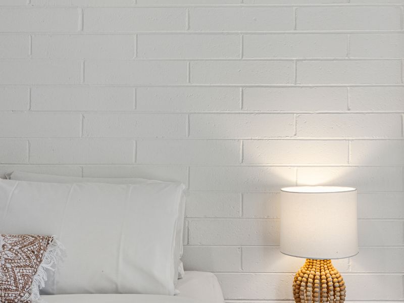 Close up of master bedroom styling and bedside lighting