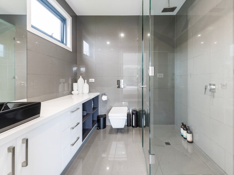 Elegant bathroom space with full-length mirror and storage