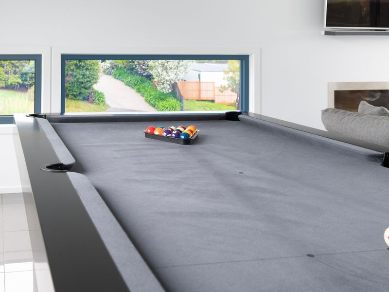 Game room featuring a full-size pool table for fun nights in.