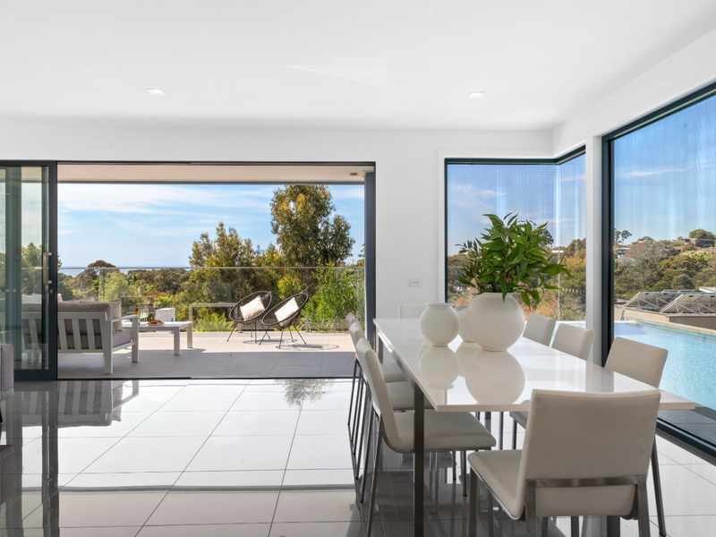 Dining area with a pool view, perfect for meals together.