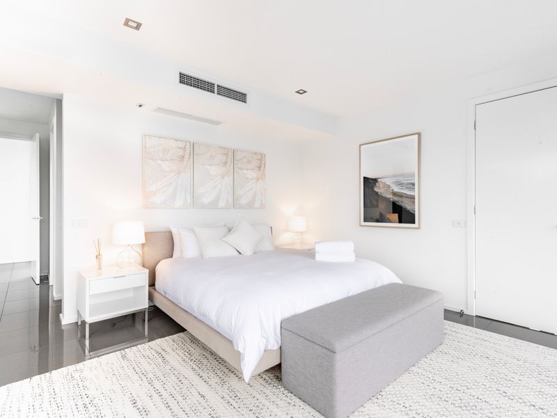 Serene master bedroom with premium bedding and soft natural light