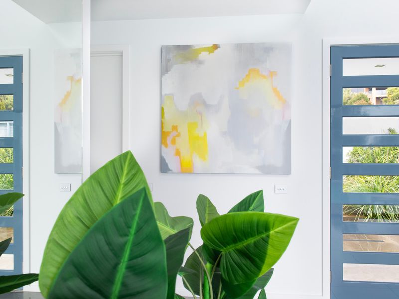 Stylish foyer featuring modern artwork and indoor greenery