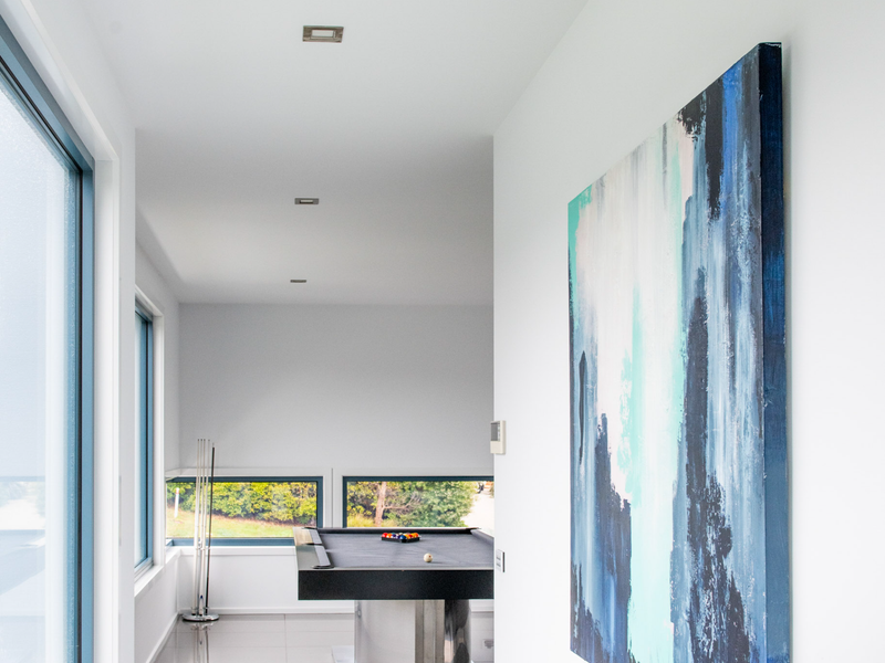 Hallway with modern decor and plenty of natural light.