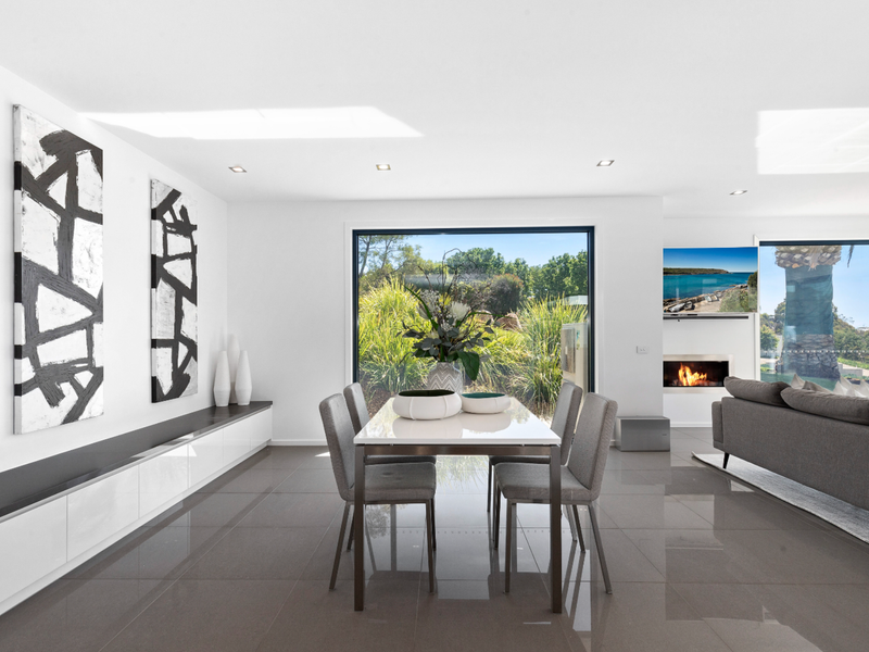Dining space bathed in natural light and garden views