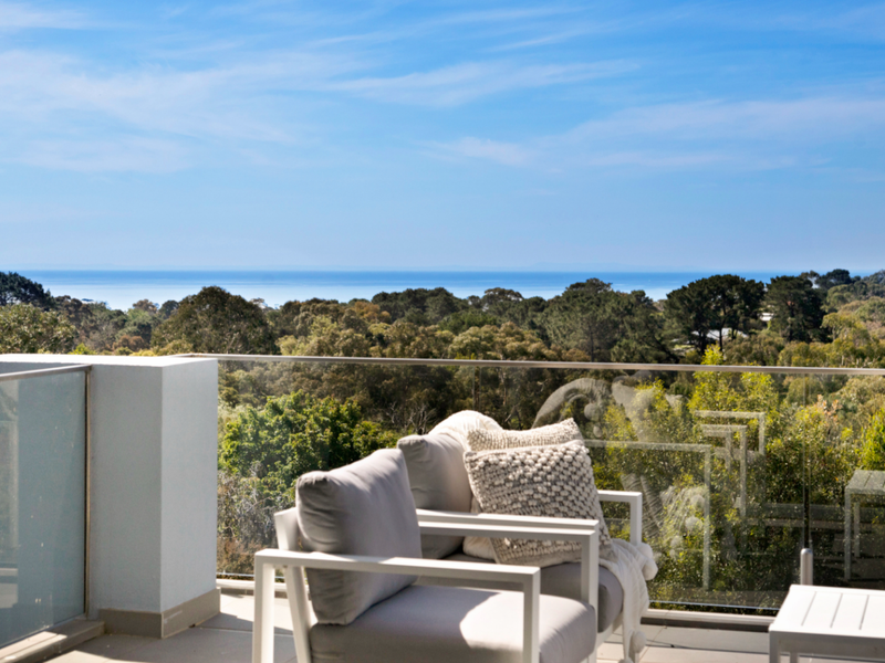 Private balcony with peaceful treetop views and outdoor seating