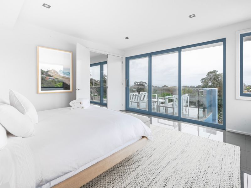 Light-filled bedroom with balcony access and tranquil outlook