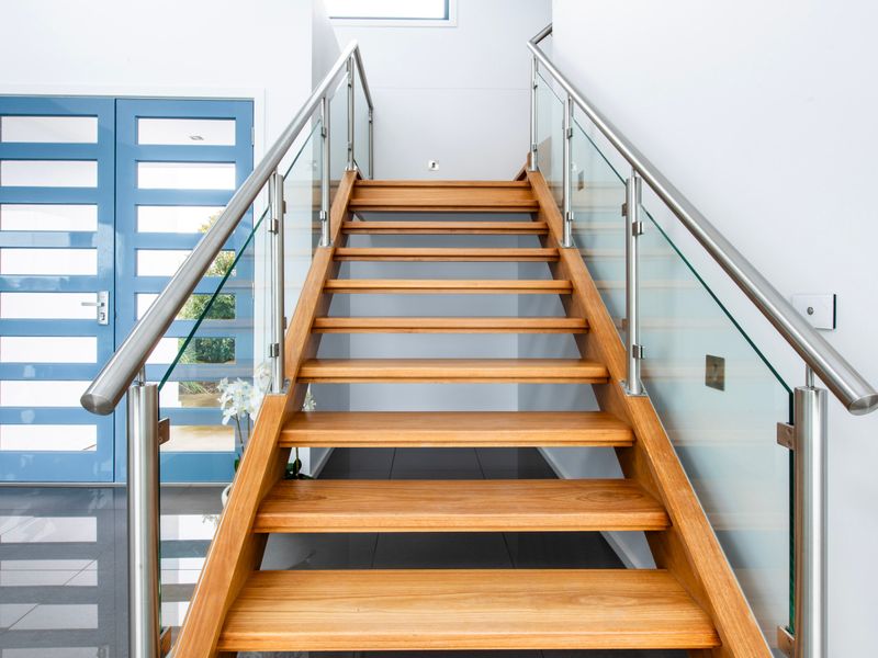 Striking staircase with timber steps and glass balustrade