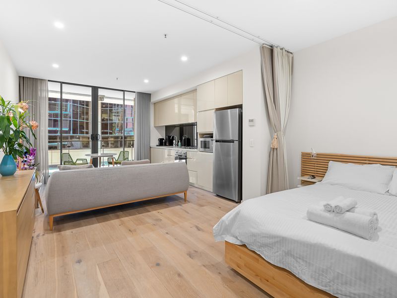 Compact comfort: A cozy space with everything you need—kitchen, living room, queen bed, and balcony.