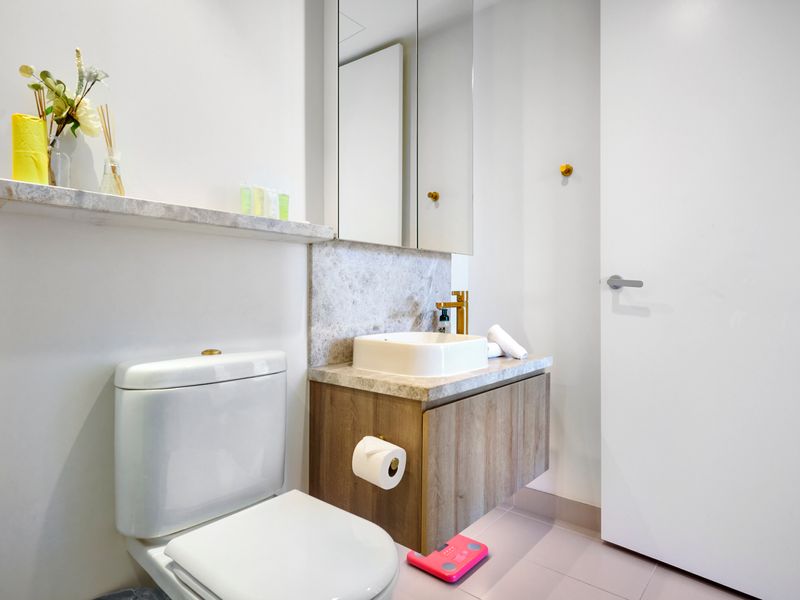 Contemporary bathroom with gold tapware and clean design
