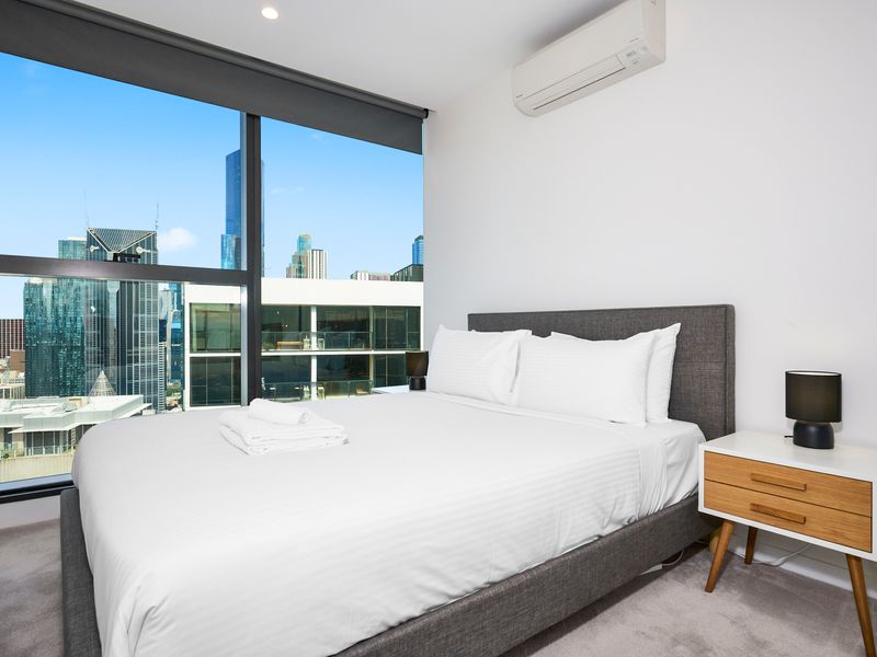 Bedroom with queen bed and sweeping city views