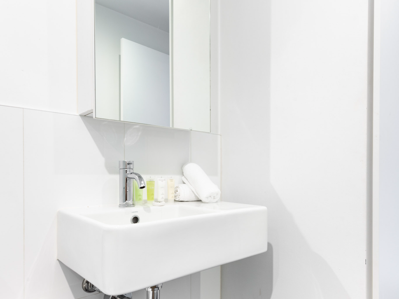 Bathroom vanity with mirror and storage behind