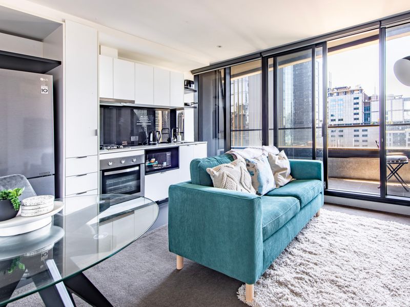 Open plan living with floor to ceiling windows and city skyline views