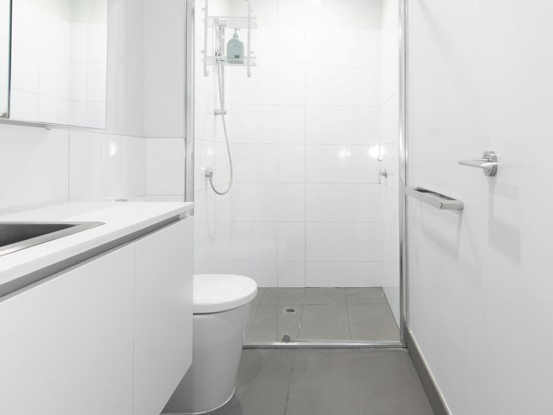 A simple and functional bathroom with a shower and toilet for your convenience.