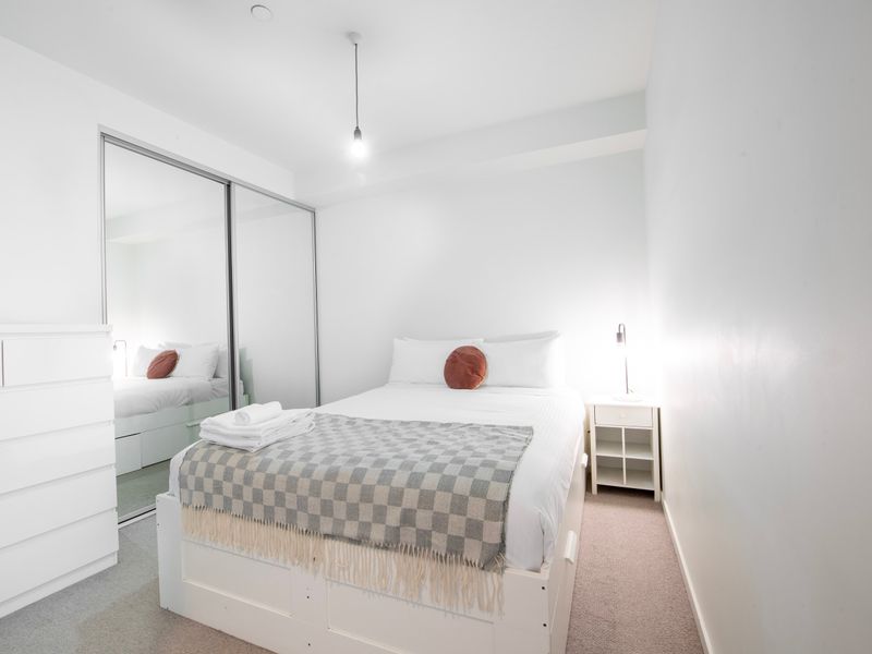 Rest easy in this comfy queen-size bed with fresh linen, ensuring a peaceful night's sleep.