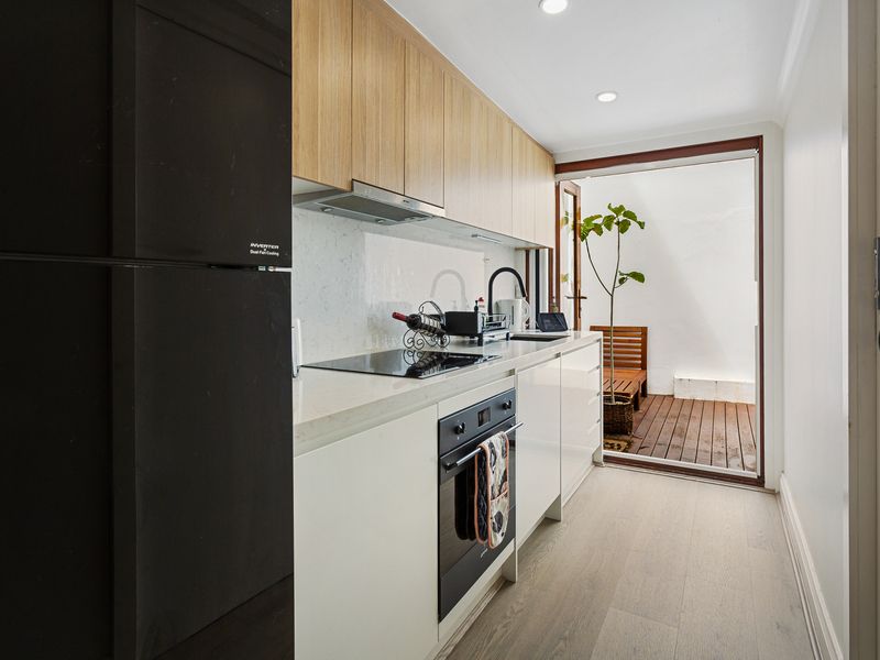 Modern kitchen with stove, oven, fridge, sink, and everything you need to cook!