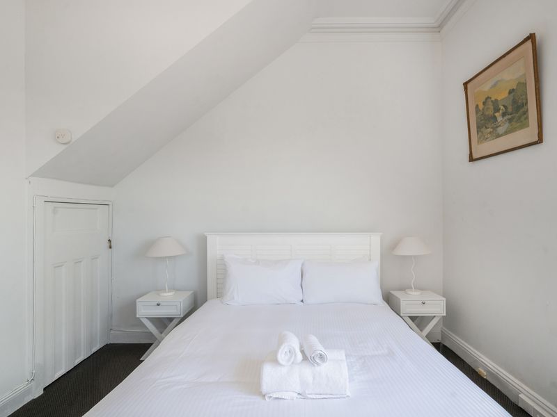 Bright and inviting bedroom with a touch of minimalist charm.