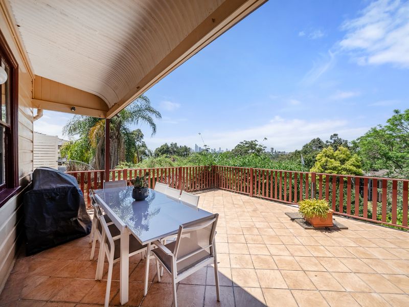 Enjoy outdoor dining with a BBQ in this spacious patio area.