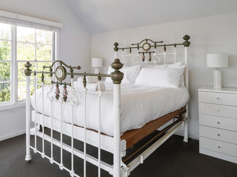 Elegant vintage bed frame in a bright and airy retreat.