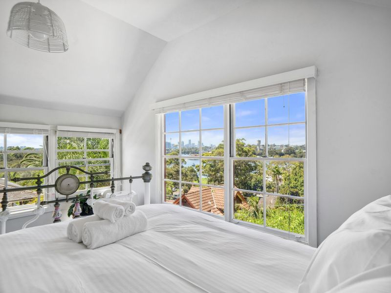 Wake up to panoramic views in this light-filled loft bedroom.