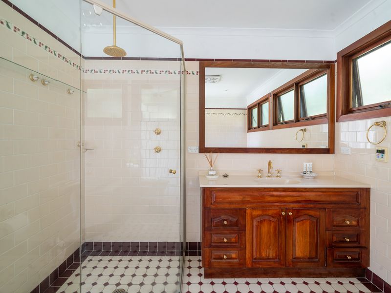 Elegant design with gold fixtures and a walk-in shower.