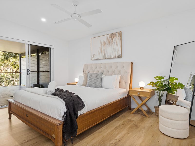 Sleep like royalty in the spacious main bedroom, featuring a luxurious king bed and soothing design