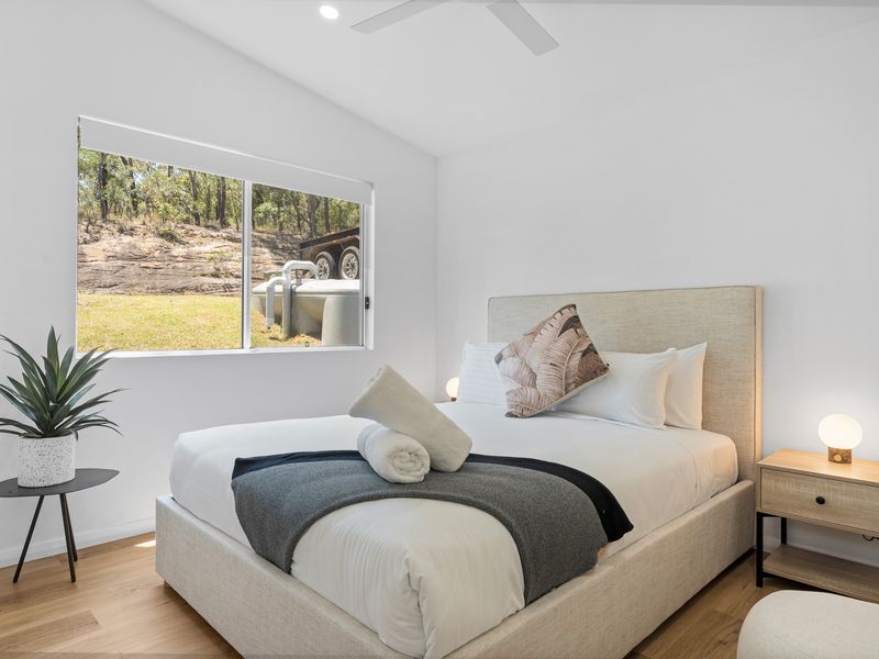 Comfort awaits in the second bedroom, with a plush queen bed and elegant decor