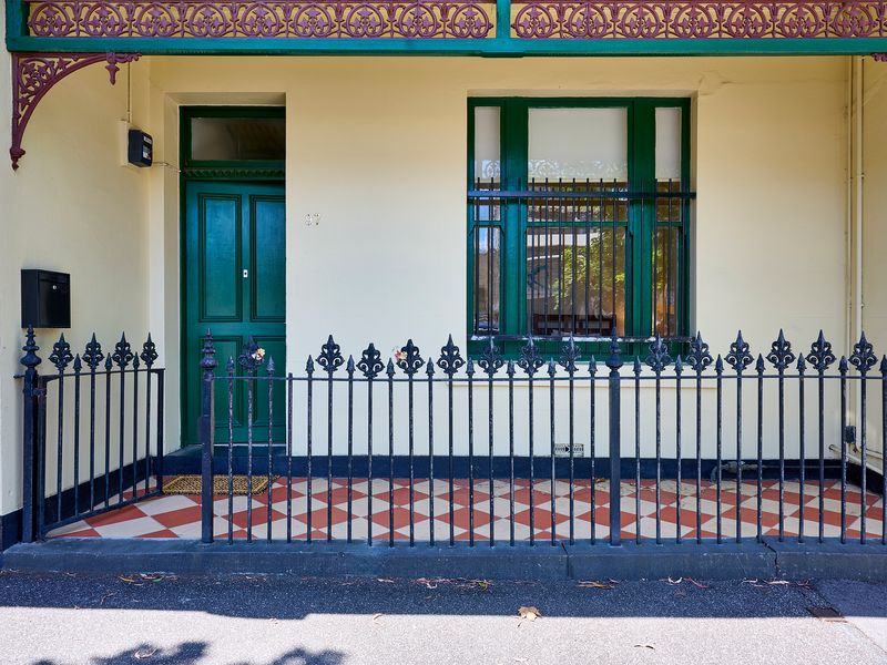Heritage Facade: Charming traditional entrance adorned with classic iron lacework and a statement green door.